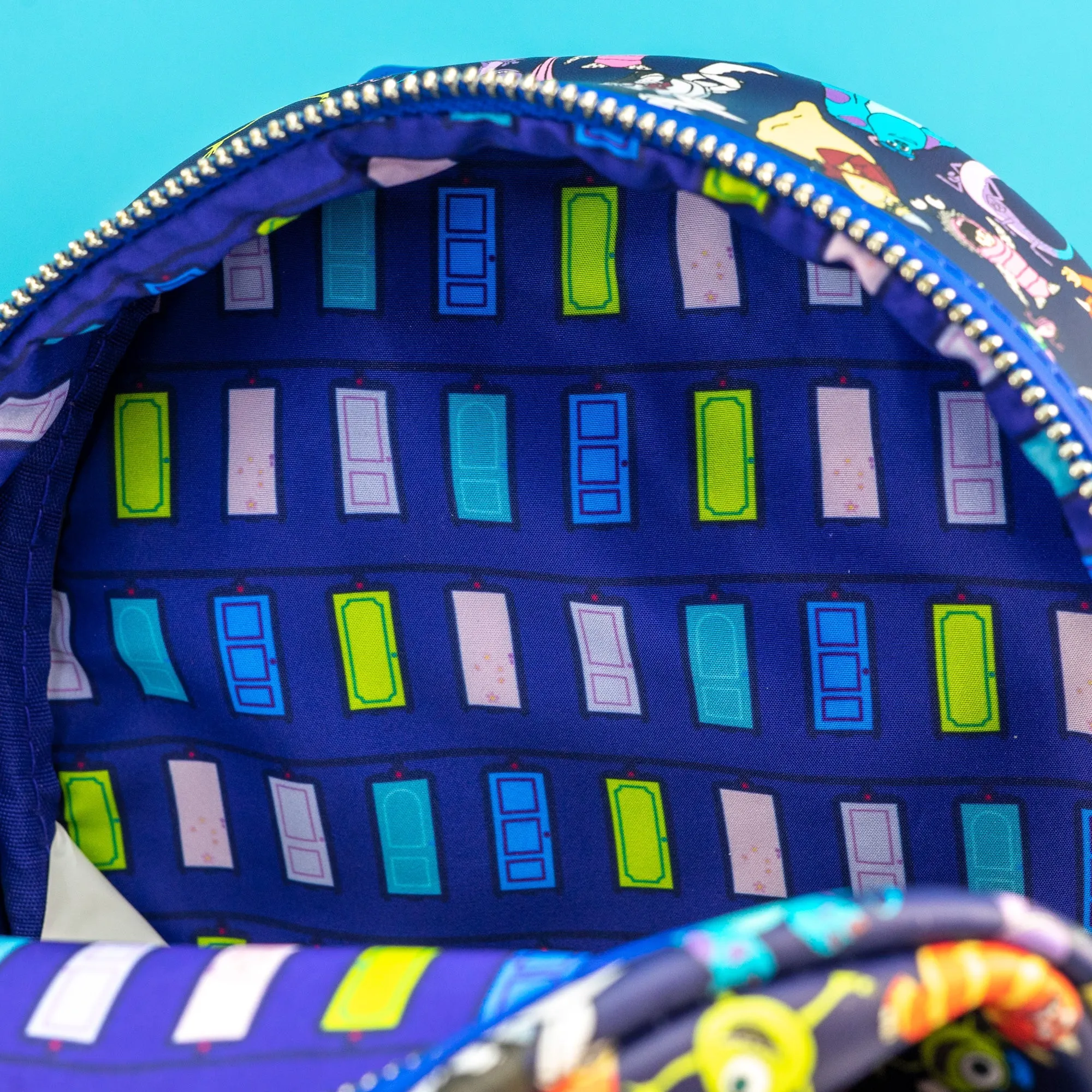 Loungefly x Disney Pixar Monsters Inc AOP Mini Backpack