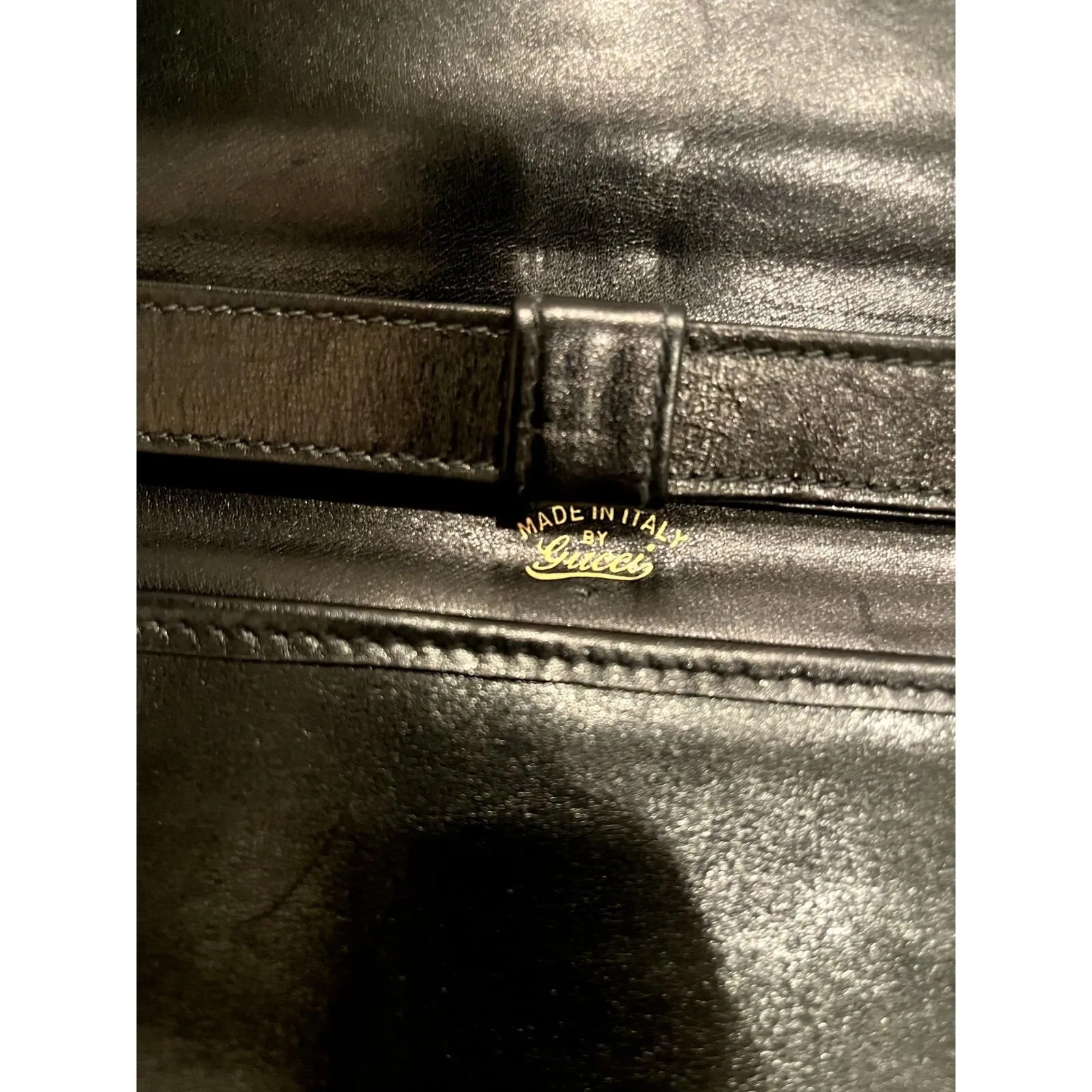 Vintage, rare, black leather, Gucci shoulder bag with a large, two-tone 'GG' emblem and removable strap