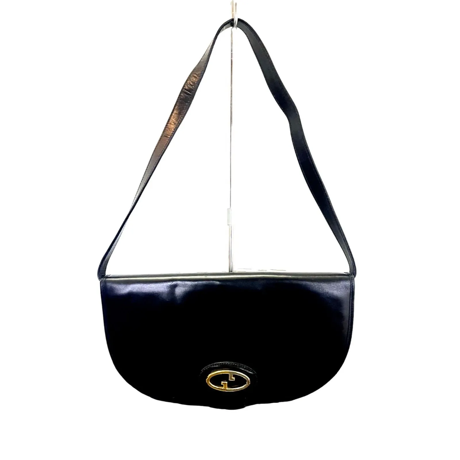 Vintage, rare, black leather, Gucci shoulder bag with a large, two-tone 'GG' emblem and removable strap